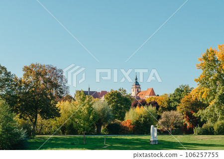 House with nice garden in fall. Flowers in the City Park of Bietigheim-Bissingen, Baden-Wuerttemberg, Germany, Europe. Autumn Park and house, nobody, bush and grenery 106257755