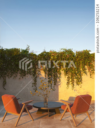 Outdoor beige scandi balcony with natural stone wall, table and orange chairs. Beautiful nature sunset light view background with green plant. 3d rendering. High quality 3d illustration Outdoor beige scandi balcony with natural stone wall, table and orange chairs. Beautiful nature sunset light view background with green plant. 3d rendering. High quality 3d illustration 106258214