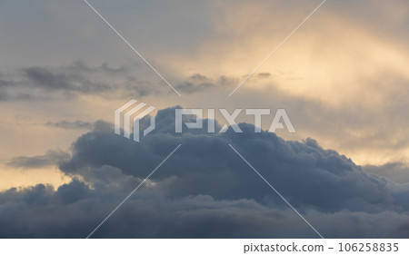 Sunset sky with majestic black clouds floating around. 106258835