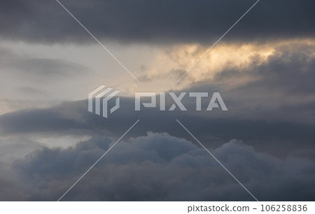 Sunset sky with majestic black clouds floating around. 106258836