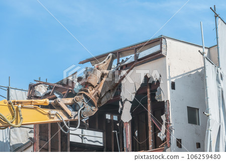 A large-scale cutting machine for cutting roofing materials at a demolition site A large-scale cutting machine for cutting roofing materials at a demolition site 106259480
