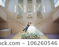 Bride and groom sitting together on the stairs 106260546