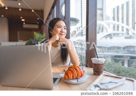 Happy smile asian woman relax at cafe with laptop indoors on day city people modern lifestyles Happy smile asian woman relax at cafe with laptop indoors on day city people modern lifestyles 106261098