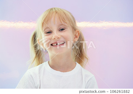 Six year smiling happy girl holding a first fallen tooth and looking at him. Six year smiling happy girl holding a first fallen tooth and looking at him. 106261882