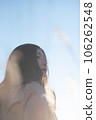 A black-haired woman looking up in the backlight 106262548