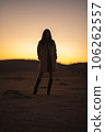 Kusasenri at sunset, silhouette of a woman in a coat 106262557