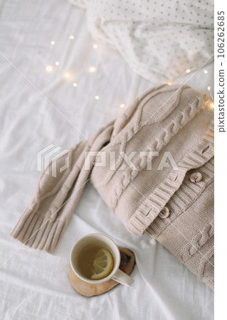 Morning. A book and a mug of tea on the bed. Sunlight in the window. Comfort. Atmosphere. Lifestyle. High quality photo Morning. A book and a mug of tea on the bed. Sunlight in the window. Comfort. Atmosphere. Lifestyle. High quality photo 106262685