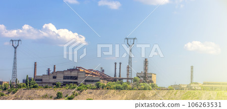 pipeline and power line support, in the photo pipeline and power line tower close-up against the background of blue sky and clouds. 106263531