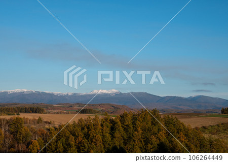 Autumn hills and snow-capped mountains 106264449