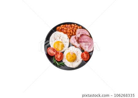 Delicious nutritious English breakfast with fried eggs and tomatoes Delicious nutritious English breakfast with fried eggs and tomatoes 106268335