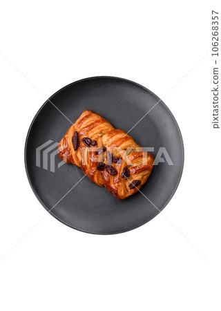 Delicious fresh baked pigtail bun with nuts and syrup 106268357