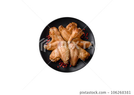 Baked chicken wings with salt, spices and herbs 106268381