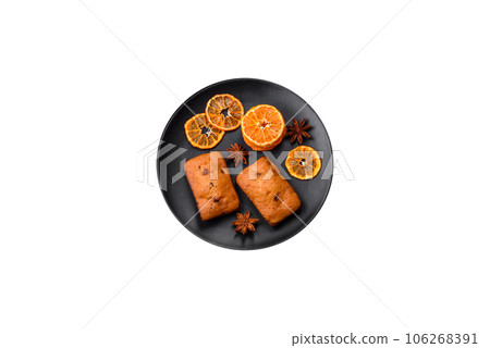Delicious chocolate muffins and dried round shaped slices of tangerine Delicious chocolate muffins and dried round shaped slices of tangerine 106268391