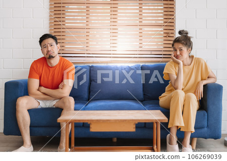 Couple lover unhappy looking at empty product on the sofa. Couple lover unhappy looking at empty product on the sofa. 106269039