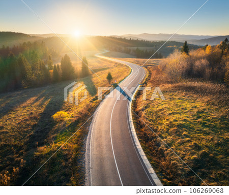 Aerial view of mountain road in forest at sunset in autumn 106269068