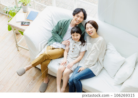Family relaxing on the sofa in the living room Family relaxing on the sofa in the living room 106269315