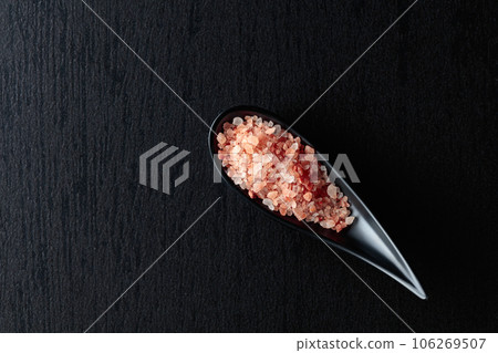 Pink salt on a black ceramic table. Pink salt on a black ceramic table. 106269507