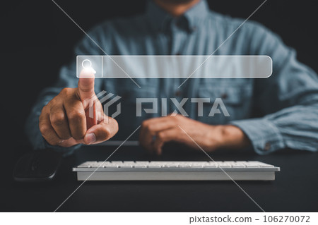 Man's finger pointing at search icon on a dark background, using a computer keyboard for search engine optimization. Browsing internet data, networking and searching concept is displayed Man's finger pointing at search icon on a dark background, using a computer keyboard for search engine optimization. Browsing internet data, networking and searching concept is displayed 106270072