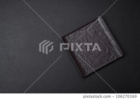 Empty black square ceramic plate on dark concrete background Empty black square ceramic plate on dark concrete background 106270169