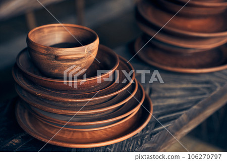 Clay plates, collection and demonstration in a workshop, small business and retail store. Clay products, on a shelf in a studio, creative store or production startup. High quality photo Clay plates, collection and demonstration in a workshop, small business and retail store. Clay products, on a shelf in a studio, creative store or production startup. High quality photo 106270797