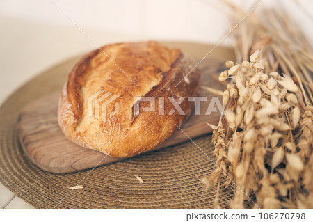 Fresh homemade wheat bread is ready for breakfast in the morning light. It lies on a wooden board with space for copying. High quality photo Fresh homemade wheat bread is ready for breakfast in the morning light. It lies on a wooden board with space for copying. High quality photo 106270798