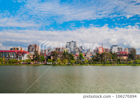 View of clouds over modern apartment buildings on lake shore in Batumi 106270894