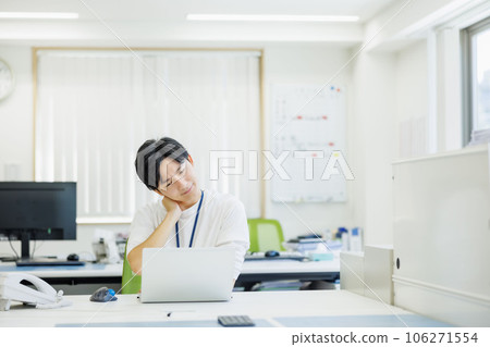 A young businessman troubled with holding his head A young businessman troubled with holding his head 106271554