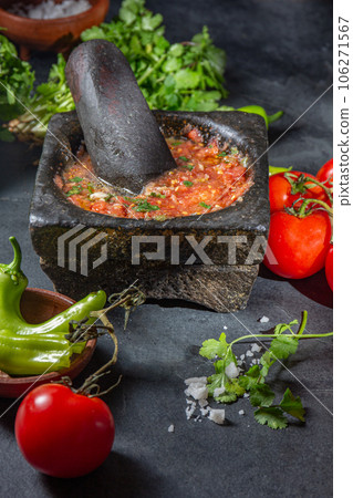 Traditional Latin American mexican Tomato sauce salsa, chilean chancho en piedra in stone mortar Traditional Latin American mexican Tomato sauce salsa, chilean chancho en piedra in stone mortar 106271567