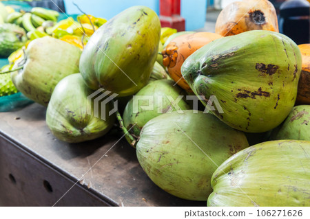 Green coconuts are on a counter at local marketplace Green coconuts are on a counter at local marketplace 106271626
