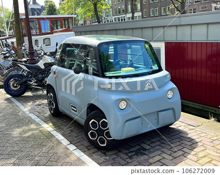 Amsterdam, Netherlands. August 11, 2023.small electric cars on the street in a big city. Amsterdam, Netherlands. August 11, 2023.small electric cars on the street in a big city. 106272009