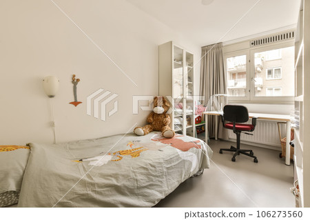 a child's room with a bed, desk and window in the corner to the right is an office 106273560