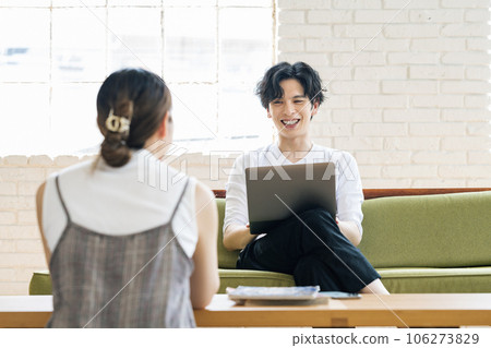 couple having a conversation in the living room 106273829