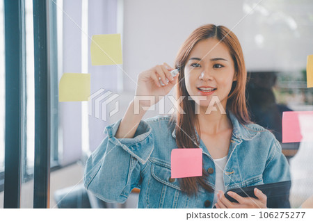 Web designers creating planning and analyzing with Colorful sticky notes on the office board.web design concept Web designers creating planning and analyzing with Colorful sticky notes on the office board.web design concept 106275277