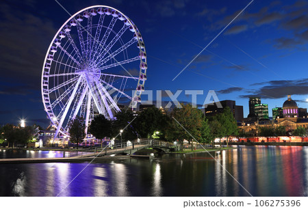 Montreal skyline illuminated at dusk, including the Giant Wheel attraction Montreal skyline illuminated at dusk, including the Giant Wheel attraction 106275396