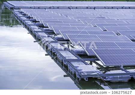 Side view of solar panels floating on water in a lake, for generating electricity from sunlight. Side view of solar panels floating on water in a lake, for generating electricity from sunlight. 106275627
