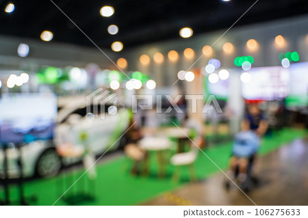Blurred images of trade fairs in the big hall. image of people walking on a trade fair exhibition or expo where business people show innovation activity and present products in a big hall. Blurred images of trade fairs in the big hall. image of people walking on a trade fair exhibition or expo where business people show innovation activity and present products in a big hall. 106275633