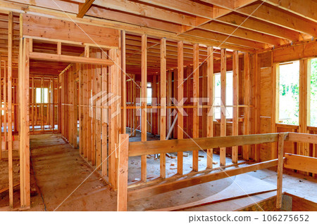 Wooden framing beams interior view new unfinished house under construction Wooden framing beams interior view new unfinished house under construction 106275652