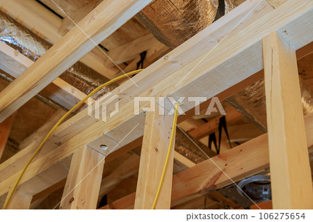 Construction essence interior view of new unfinished house with wooden beams frame Construction essence interior view of new unfinished house with wooden beams frame 106275654