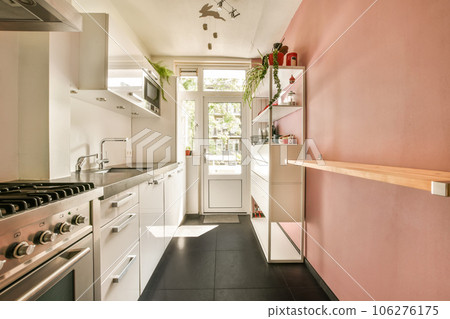 a kitchen area with pink walls and white appliances on the stoves, sink and dishwasher in the corner a kitchen area with pink walls and white appliances on the stoves, sink and dishwasher in the corner 106276175