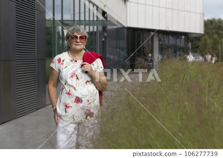 Portrait Real Beautiful Senior Elderly Woman With Gray Silver Hair in City Near Shopping Mall At Summer Day. Beautiful Retired Mature Lady With Sun Glasses. Authentic Lifestyle. Horizontal, Copy Space 106277739