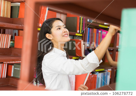 female student reading a book 106278772