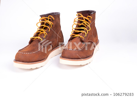 Brown boot on white background. Brown boot on white background. 106279283