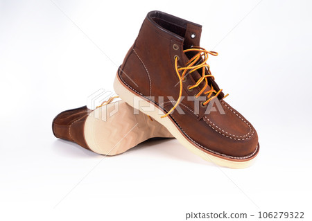 Brown boot on white background. 106279322