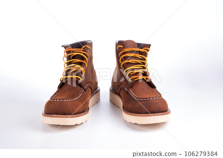 Brown boot on white background. Brown boot on white background. 106279384