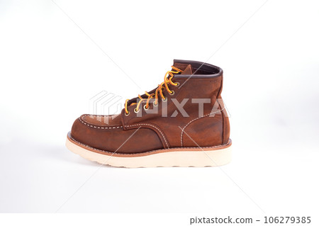 Brown boot on white background. Brown boot on white background. 106279385