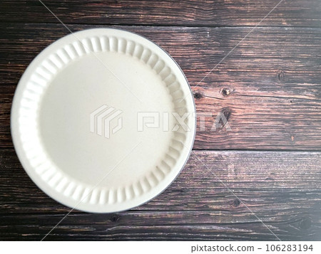 white plate on wooden table white plate on wooden table 106283194