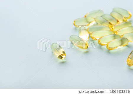 Omega 3 fish liver oil capsules on blue background. Close up, front view. 106283226