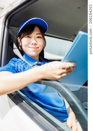 Female driver checking delivery schedule Female driver checking delivery schedule 106284201