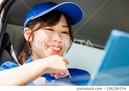 Female driver checking delivery schedule 106284334