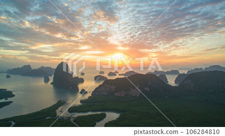 aerial view Amazing light of nature cloudscape sky above Samed Nang Chee Phang Nga archipelago. Imagine a fantasy bright red sky at sunrise from a bird's eye view. tropical landscape background. aerial view Amazing light of nature cloudscape sky above Samed Nang Chee Phang Nga archipelago. Imagine a fantasy bright red sky at sunrise from a bird's eye view. tropical landscape background. 106284810